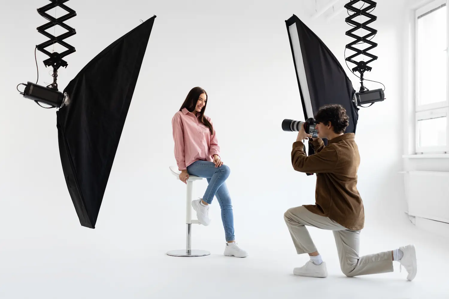 Fashion shoot with a model under studio lights on a seamless backdrop