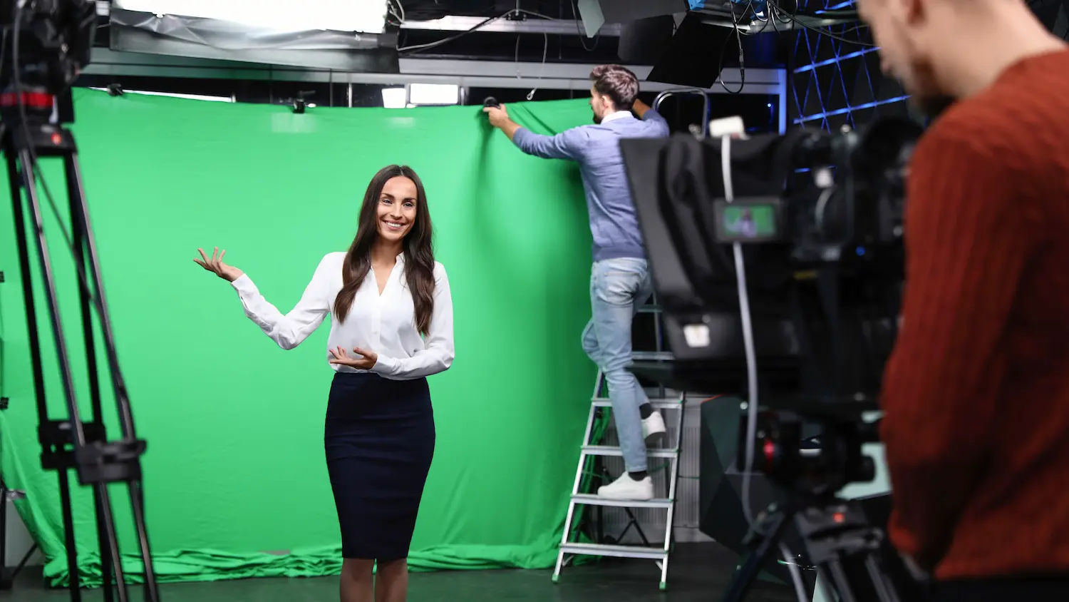 Wide view of the studio green-screen stage with lighting