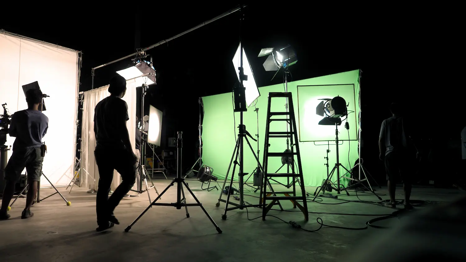 Talent standing on a green-screen cyclorama during a studio production
