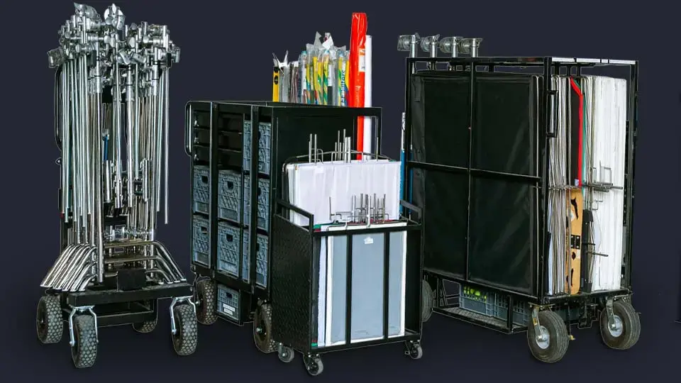C-stands, flags, apple boxes, and other grip equipment staged in the studio